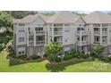 Elegant condo with private balconies, manicured lawn, and charming garden beds at 108 Pier 33 Dr # 414, Mooresville, NC 28117