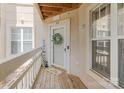 Front porch with a decorated door and welcome mat at 108 Pier 33 Dr # 414, Mooresville, NC 28117