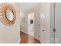 Inviting hallway with wood floors and decorative mirror at 108 Pier 33 Dr # 414, Mooresville, NC 28117