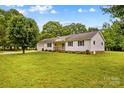 Well-maintained home with manicured front lawn, shutters, and shade trees at 115 Three Oaks Ln, Statesville, NC 28677