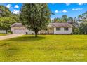 Home with a large front yard and mature shade tree plus an attached two-car garage at 115 Three Oaks Ln, Statesville, NC 28677