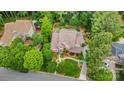 Stunning aerial view of a brick home nestled on a spacious lot surrounded by mature trees and landscaped grounds at 118 Sunrise Cir, Mooresville, NC 28117