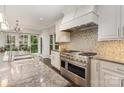 Modern kitchen features stainless steel appliances, granite countertops, and a mosaic backsplash at 118 Sunrise Cir, Mooresville, NC 28117