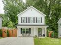 Charming two-story home with a welcoming front porch and lush landscaping at 1209 Gaston Ave, Gastonia, NC 28052