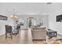 Bright and open-concept living room with recessed lighting, modern furnishings, and sliding glass doors at 12110 Chesapeake Mallard Dr, Charlotte, NC 28262