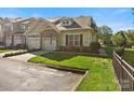 Beautiful townhome featuring a two car garage, stone details, and a pristine lawn at 1219 Crown Vista Dr, Fort Mill, SC 29707