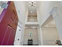 Two-story foyer featuring an open staircase and elegant chandelier at 126 W Warfield Dr, Mooresville, NC 28115
