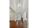 Bright, two-story foyer with hardwood floors and transom window above the front door at 126 W Warfield Dr, Mooresville, NC 28115