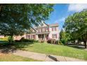 Charming two-story home with red shutters, well-manicured lawn and beautiful landscaping at 126 W Warfield Dr, Mooresville, NC 28115
