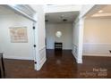 View of an open living area with hardwood flooring and classic wainscoting at 126 W Warfield Dr, Mooresville, NC 28115