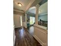 Inviting home entryway with hardwood floors, modern wainscoting and archway at 13241 Woodland Farm Dr, Charlotte, NC 28215
