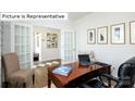 Well-lit home office with French doors, a wooden desk, and comfortable seating at 1365 Secrest Commons Dr, Monroe, NC 28112