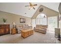 Bright living room with vaulted ceilings, plush seating, and a large arched window at 14340 Kendalton Meadow Dr, Mint Hill, NC 28227