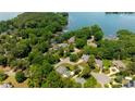 Beautiful aerial view of lakefront homes nestled among lush trees with private docks on a sunny day at 19523 Sunnypoint Ct, Cornelius, NC 28031
