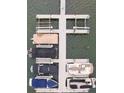 Aerial view of a boat dock featuring multiple slips with covered and uncovered boats at 19523 Sunnypoint Ct, Cornelius, NC 28031