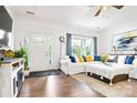 Bright living room with white sofa, wood floors, and large windows, creating a cozy and inviting space at 1994 Hollybrook Ln # 17, Lancaster, SC 29720