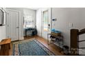 Inviting entryway featuring hardwood floors, a console table, and natural light from a windowed door at 2518 Marshall Pl, Charlotte, NC 28203