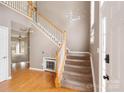 Grand foyer with hardwood floors, carpeted stairs, and natural light, creating a welcoming entrance to the home at 2608 Yarrow Rd, Charlotte, NC 28213