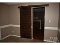 A living room entrance with a wood sliding door provides a stylish transition to other areas at 2608 Yarrow Rd, Charlotte, NC 28213