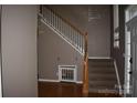 Interior shot of the home's foyer with staircase featuring wooden steps and white railing at 2608 Yarrow Rd, Charlotte, NC 28213