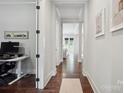 Bright hallway with hardwood floors leading to the living area and an office space at 2637 Springway Dr, Charlotte, NC 28205