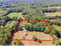 An aerial shot showcases the property's expansive land, potential homesites, and tree coverage at 290 Glenmere Ln, Mooresville, NC 28115