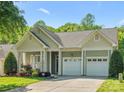 Charming home with a well-manicured lawn, a two-car garage, and beautiful landscaping at 3068 Streamhaven Dr, Lancaster, SC 29707