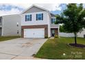Charming two-story home features a well-manicured lawn and attached two-car garage at 316 Gaines Rd, Clover, SC 29710