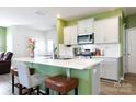 Beautiful kitchen boasts an island with bar seating and white cabinets at 316 Gaines Rd, Clover, SC 29710