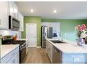 Open concept kitchen with stainless steel appliances, a large island, and wood flooring at 316 Gaines Rd, Clover, SC 29710