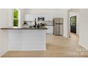 Modern kitchen boasting white cabinets, stainless appliances, granite counters and a breakfast bar at 317 S Pink St, Cherryville, NC 28021
