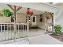 Welcoming front porch with hanging flower baskets and a charming 'Hello Sunshine' sign at 3690 Birchwood Ln, Denver, NC 28037