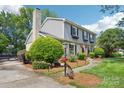 Angle view of a home with a brick and gray siding exterior, complemented by a landscaped yard and garden at 3918 Rea Rd, Charlotte, NC 28226
