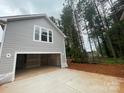 Exterior shot of a garage with a large opening and a concrete driveway at 4021 Grommet Ct # 4, Matthews, NC 28105