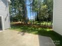 View of the backyard featuring a concrete patio, and plenty of mature trees at 4021 Grommet Ct, Matthews, NC 28105