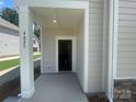 Inviting front porch with white pillars, displaying the house number and a glimpse inside the home at 4025 Grommet Ct, Matthews, NC 28105