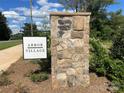 Stone community sign for Arbor Village, surrounded by greenery, provides a welcoming entrance at 4033 Grommet Ct # 7, Matthews, NC 28105