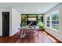 Bright home office with custom green built-ins, sleek desk, and natural light from a large window at 4038 Zilker Park Dr, Charlotte, NC 28217