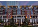 Beautiful condo building exterior with brick facade, balconies, columns and manicured landscaping at 435 S Tryon St # 601, Charlotte, NC 28202