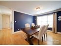 Well-lit dining room featuring a wooden table, upholstered chairs, and a large window at 4618 Dallas High Shoals Hwy, Dallas, NC 28034