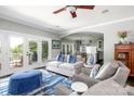 Open-concept living room leading to the kitchen, featuring a stone fireplace and French doors to the deck at 46827 Tall Whit Rd, New London, NC 28127