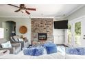 Cozy living room featuring a stone fireplace, plush seating, and French doors to the outside at 46827 Tall Whit Rd, New London, NC 28127