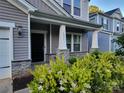Inviting covered front porch with decorative stone accents and lush landscaping at 5031 Burnwald Ct, Fort Mill, SC 29715