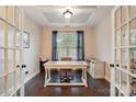 Bright office space with hardwood floors, a large window, and a stylish desk at 5105 Paisano Ln, Waxhaw, NC 28173