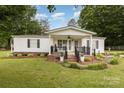 Charming single-story home featuring a welcoming front porch and beautifully landscaped front yard at 733 Osteen Rd, York, SC 29745