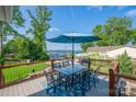 Outdoor dining on the deck with seating for six and views of the lake and boats at 8005 Island View Ct, Denver, NC 28037