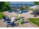 Luxurious pool area with a hot tub, lounge chairs, and ample seating for relaxation at 8005 Island View Ct, Denver, NC 28037