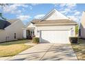 Home featuring a two-car garage, well-maintained lawn, and inviting curb appeal at 8033 Pawleys Ct, Fort Mill, SC 29707
