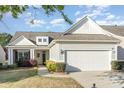 Charming home with a two-car garage, manicured landscaping, and a welcoming front porch at 8033 Pawleys Ct, Fort Mill, SC 29707
