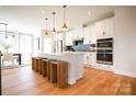 Bright kitchen with a center island with seating, stainless steel appliances, and hardwood floors at 8044 Cedarsmith Ct, Charlotte, NC 28217